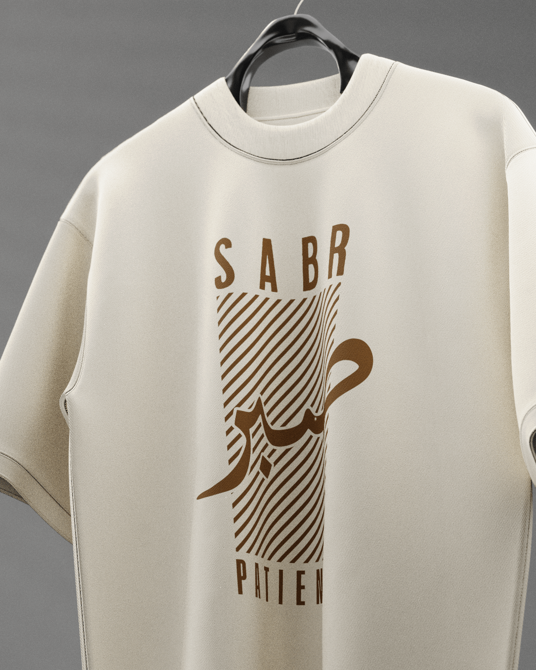 Beige sweatshirt with brown graphic design and text on a hanger against a gray background