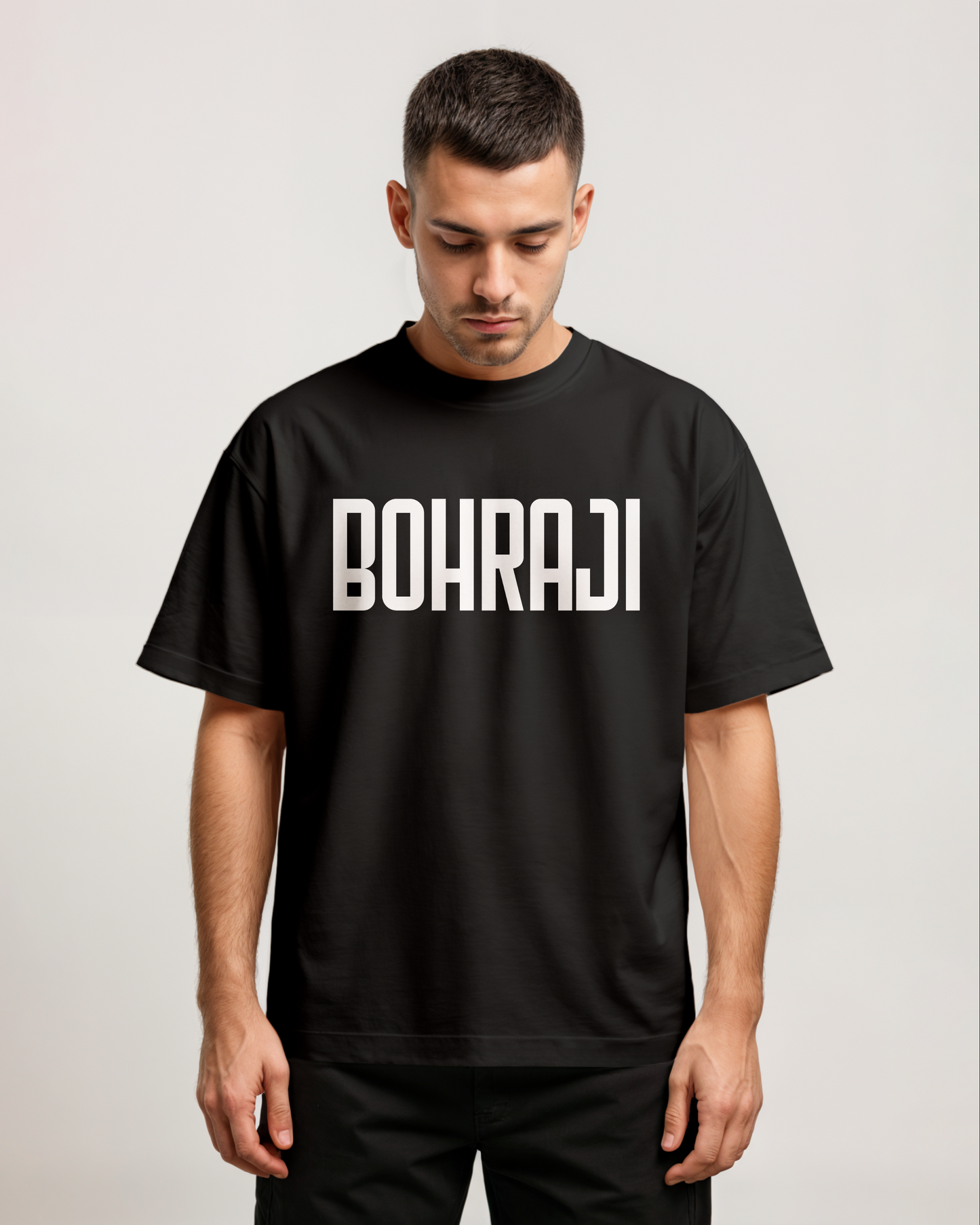 Person wearing a black t-shirt with 'BOHRAJI' text on a plain background